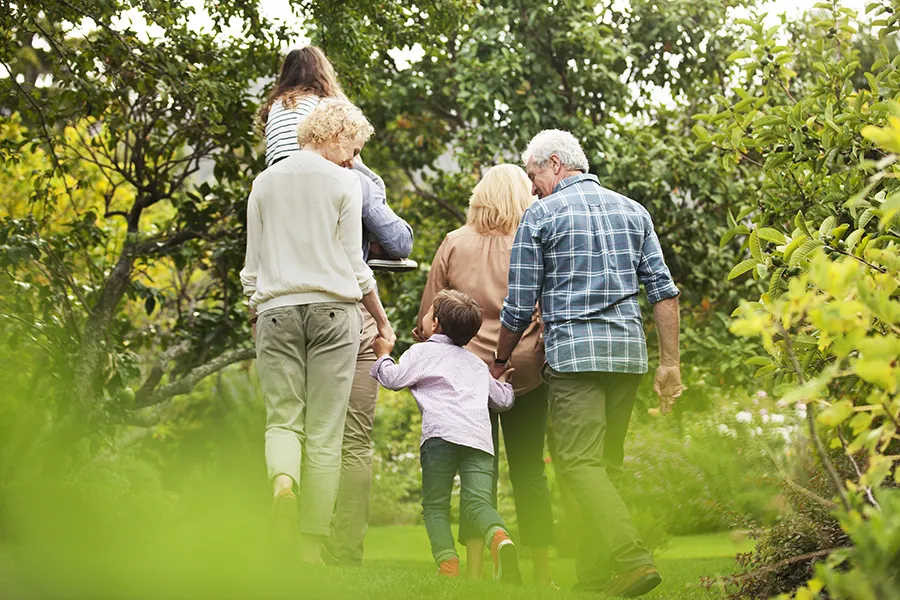 Multi-generational family walking in a garden