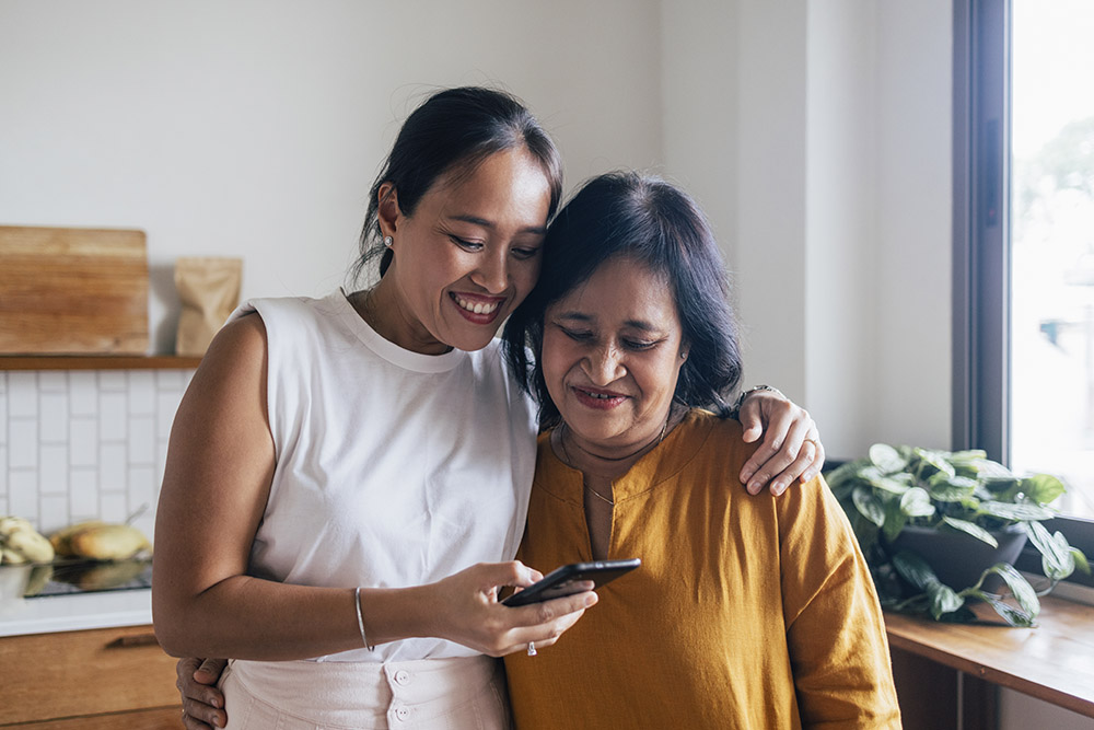 Mother and daughter looking at a phone together